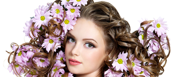 Flowers in long hair of beautiful and sexy woman